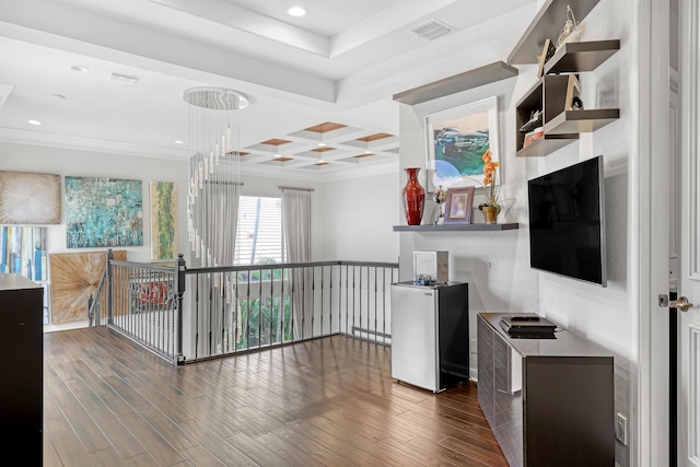 interior space with beam ceiling, crown molding, coffered ceiling, and dark hardwood / wood-style floors