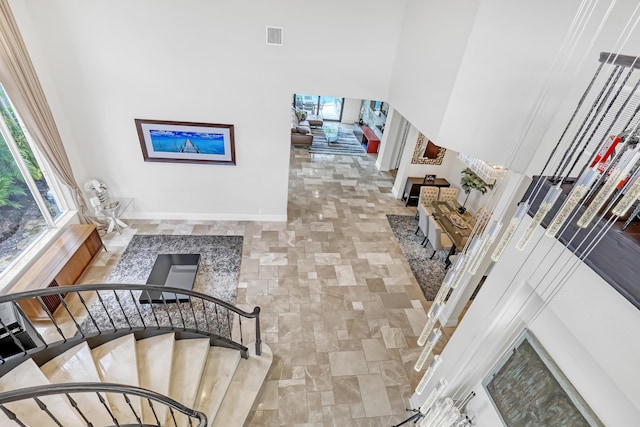 stairway featuring a high ceiling