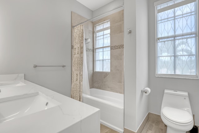 full bathroom with shower / bathtub combination with curtain, vanity, and toilet