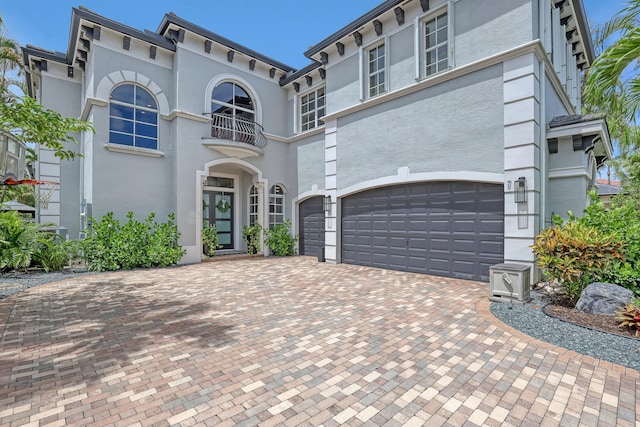 view of front of home with a balcony and a garage