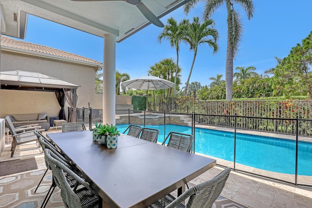 view of swimming pool with ceiling fan and a patio area