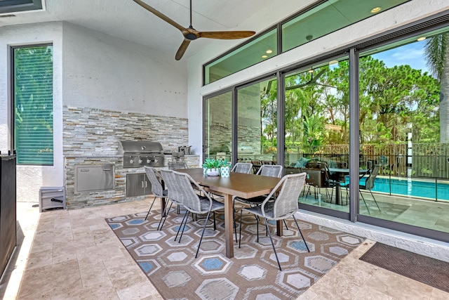 sunroom featuring ceiling fan