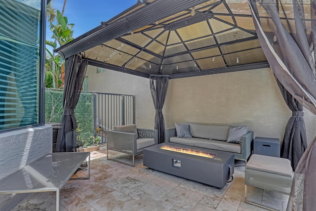 view of patio / terrace with a gazebo and an outdoor living space with a fire pit