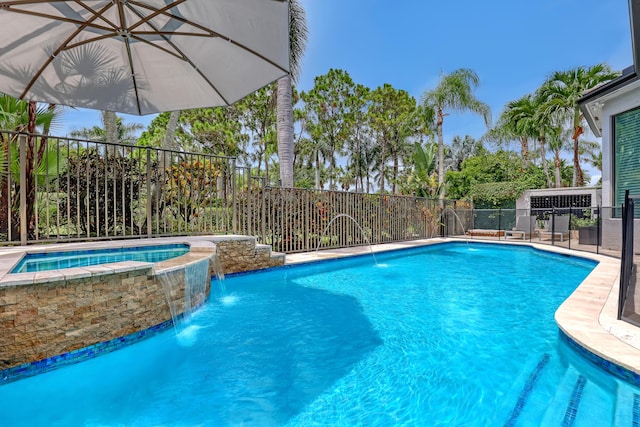 view of swimming pool featuring pool water feature and an in ground hot tub