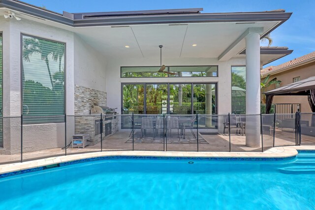 view of pool with a patio, an in ground hot tub, and a gazebo