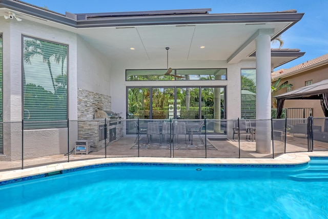 view of swimming pool with area for grilling, exterior kitchen, and a patio area