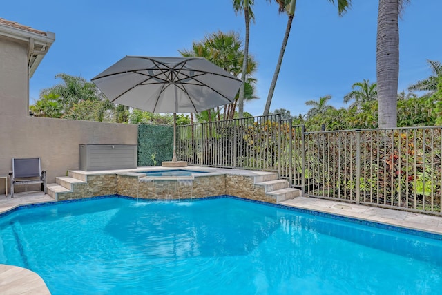 view of swimming pool with an in ground hot tub