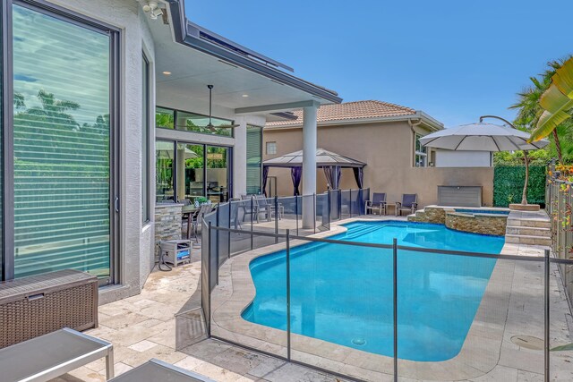 view of swimming pool with an in ground hot tub and pool water feature