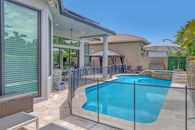 view of pool featuring a gazebo, a patio, and an in ground hot tub