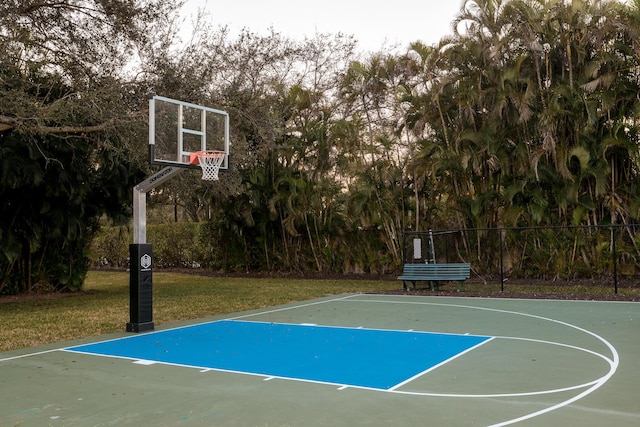 view of sport court featuring a lawn