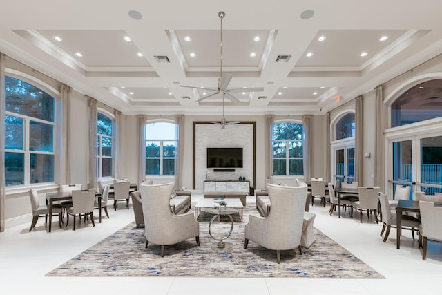 living room with a towering ceiling, ornamental molding, coffered ceiling, and light tile patterned floors