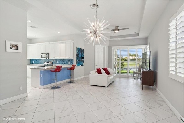 living room with ceiling fan with notable chandelier