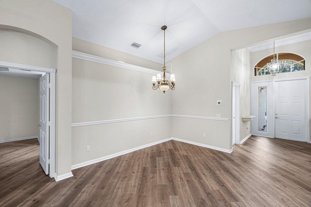 entrance foyer with wood finished floors, visible vents, vaulted ceiling, and a chandelier