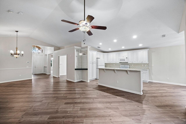 unfurnished living room with lofted ceiling, recessed lighting, dark wood finished floors, and ceiling fan with notable chandelier