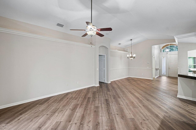 unfurnished living room with lofted ceiling, visible vents, baseboards, wood finished floors, and ceiling fan with notable chandelier