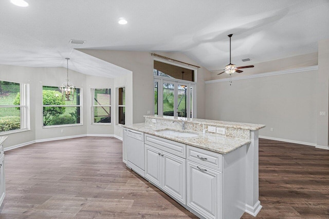 kitchen with wood finished floors, vaulted ceiling, ceiling fan with notable chandelier, dishwasher, and a sink