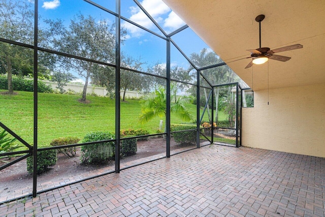 unfurnished sunroom with ceiling fan