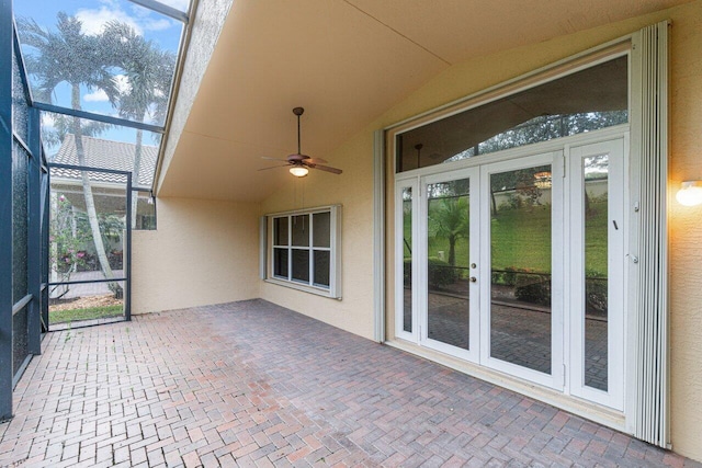 unfurnished sunroom featuring ceiling fan and lofted ceiling