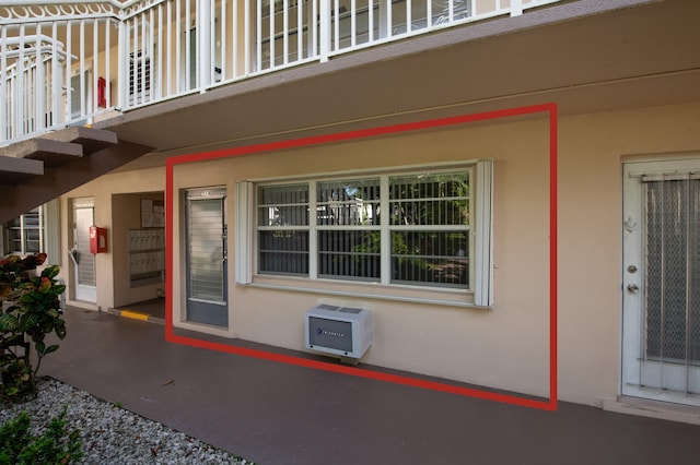 entrance to property with a balcony and heating unit