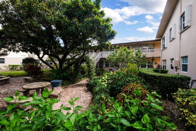 view of yard featuring a patio and a balcony