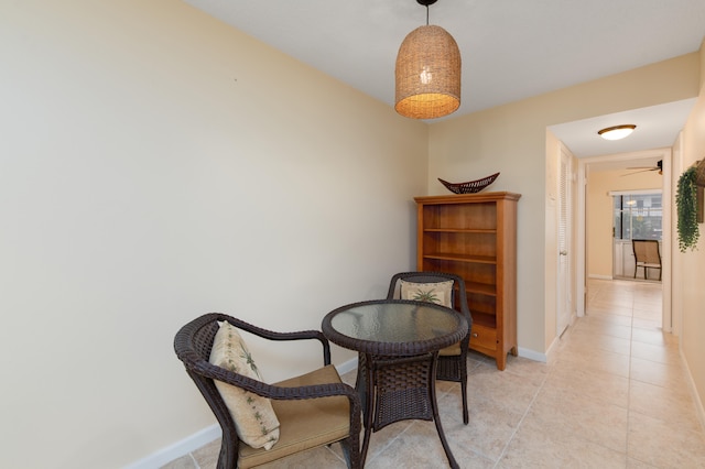 sitting room featuring light tile patterned flooring and ceiling fan