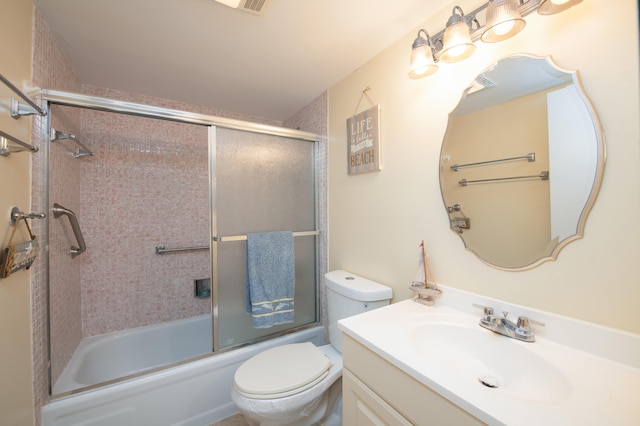 full bathroom featuring vanity, bath / shower combo with glass door, and toilet