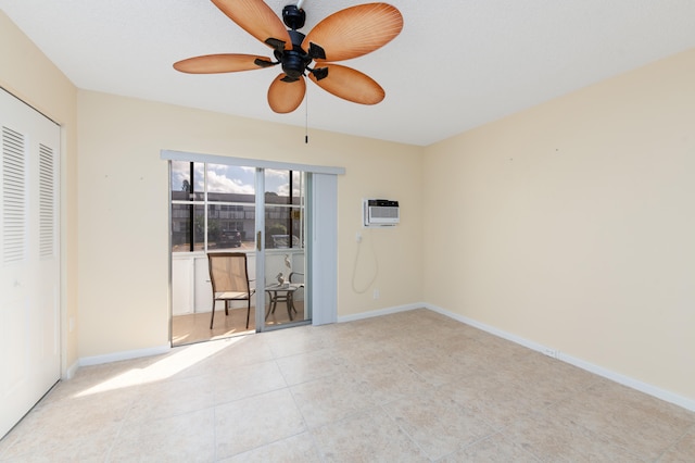 spare room featuring ceiling fan and a wall unit AC