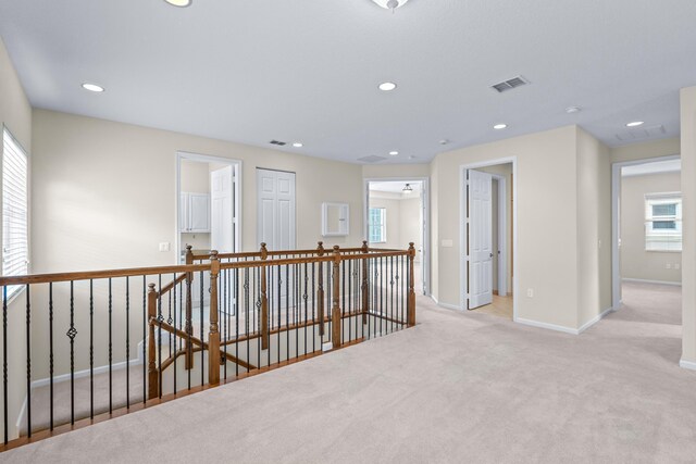 carpeted spare room featuring a chandelier