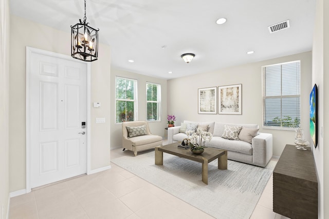 living room with light tile patterned flooring, visible vents, recessed lighting, and a chandelier