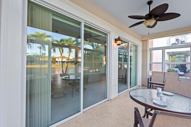 sunroom featuring ceiling fan