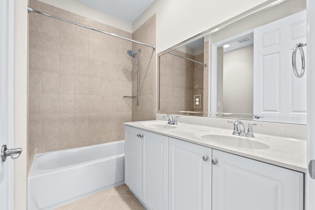 bathroom with tile patterned floors, tiled shower / bath combo, and vanity