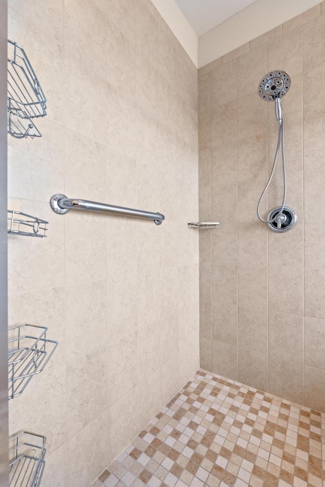 bathroom with tiled shower