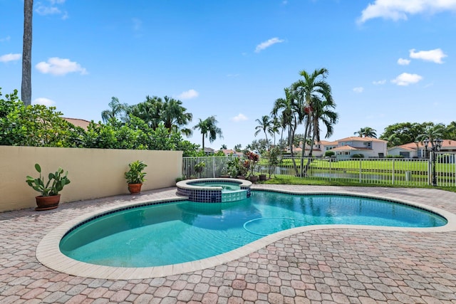 view of pool featuring a patio area and an in ground hot tub