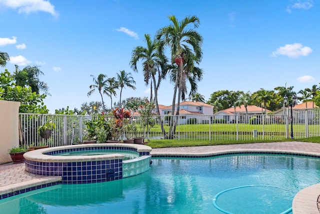 view of swimming pool featuring an in ground hot tub