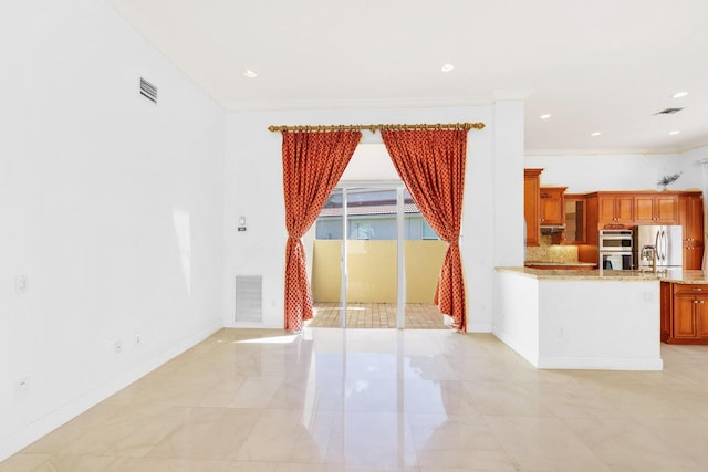 interior space featuring tasteful backsplash, crown molding, stainless steel appliances, and light stone counters