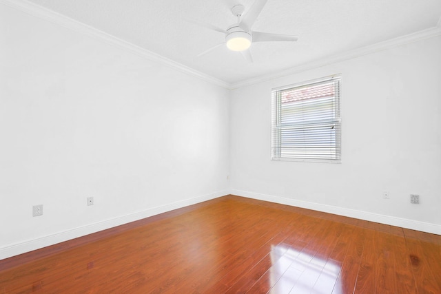 empty room with crown molding, ceiling fan, and wood-type flooring