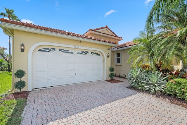 mediterranean / spanish house with a garage