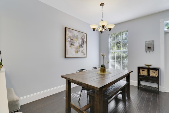 dining room featuring dark hardwood / wood-style flooring and a notable chandelier