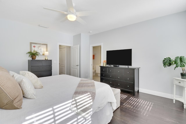 bedroom with connected bathroom, ceiling fan, and dark wood-type flooring