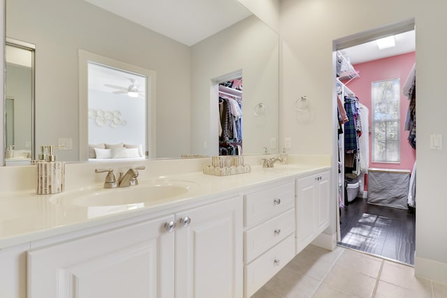 bathroom with tile patterned flooring, vanity, and ceiling fan