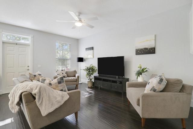 living room featuring ceiling fan and dark wood-type flooring