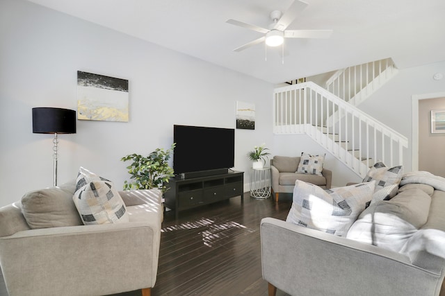 living room featuring ceiling fan and dark wood-type flooring