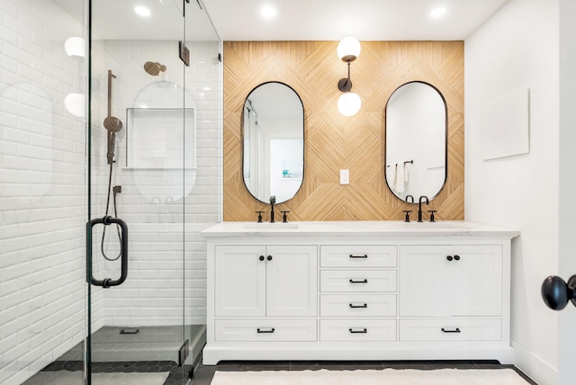 bathroom featuring vanity and a shower with shower door