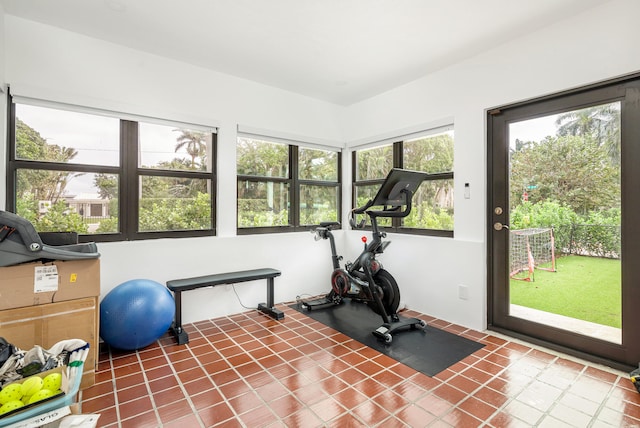 workout room featuring tile patterned flooring and plenty of natural light