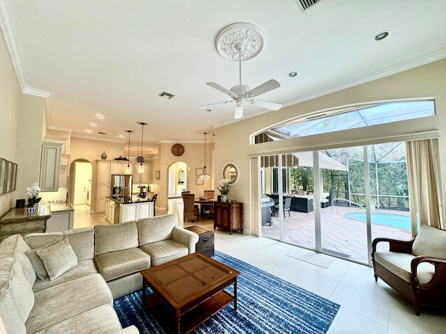 tiled living room featuring ceiling fan and ornamental molding