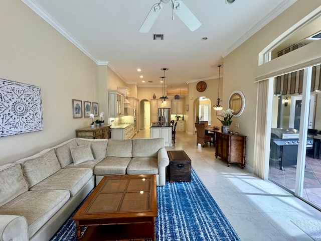 tiled living room featuring ornamental molding and ceiling fan