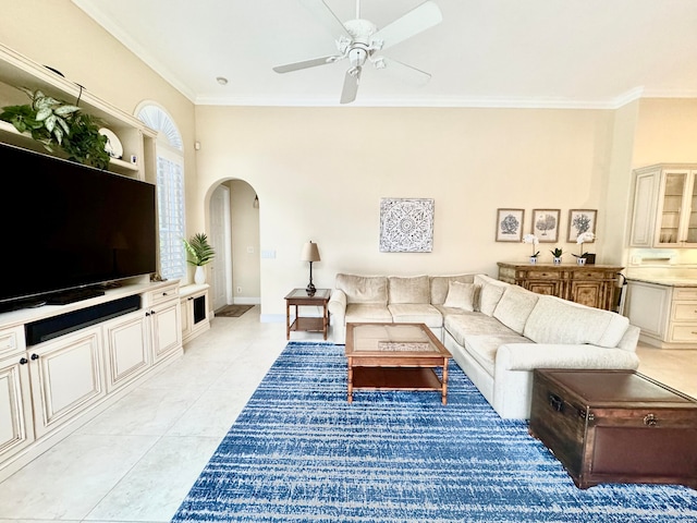 living room featuring crown molding, light tile patterned flooring, and ceiling fan