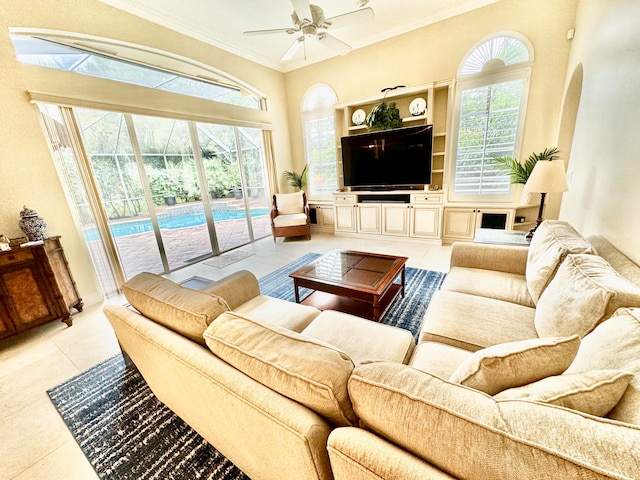 tiled living room with ornamental molding and ceiling fan