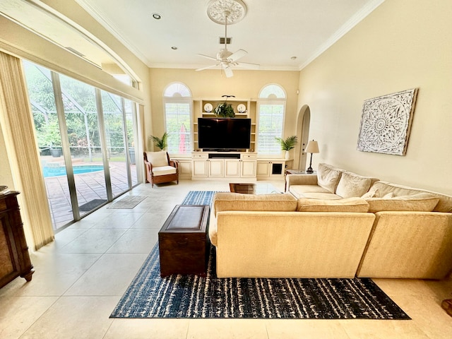 living room with crown molding, ceiling fan, and light tile patterned floors