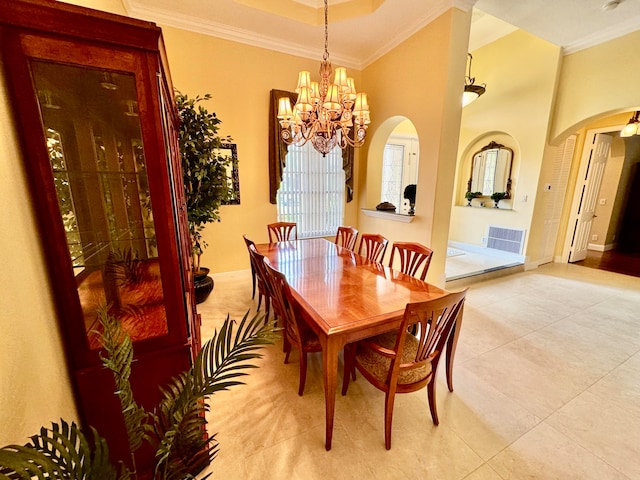 tiled dining space featuring an inviting chandelier and ornamental molding